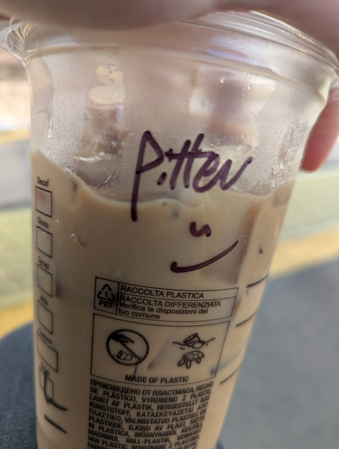 An iced latte with &ldquo;Pitter&rdquo; written on the cup